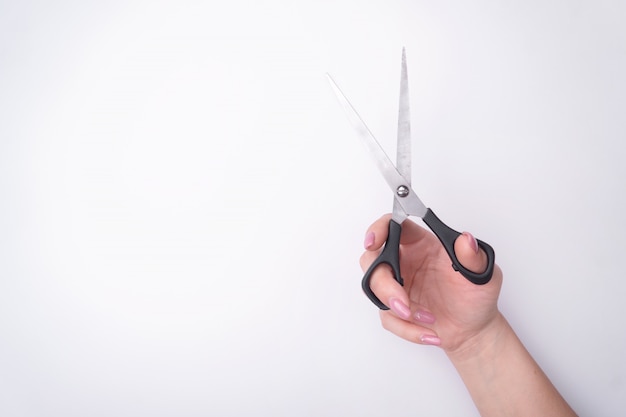 Fashion woman's hand with a gentle manicure holds a tool. 