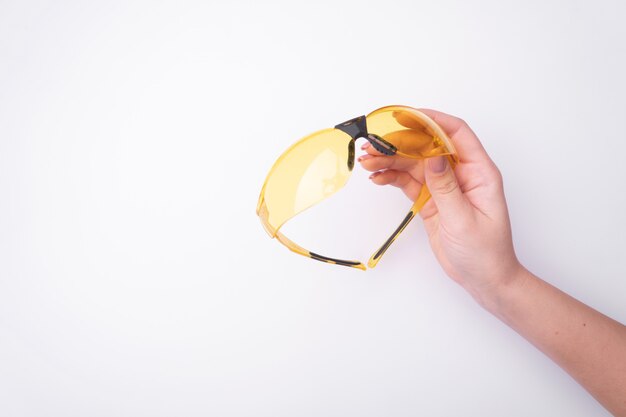 Fashion woman's hand with a gentle manicure holds a tool. 