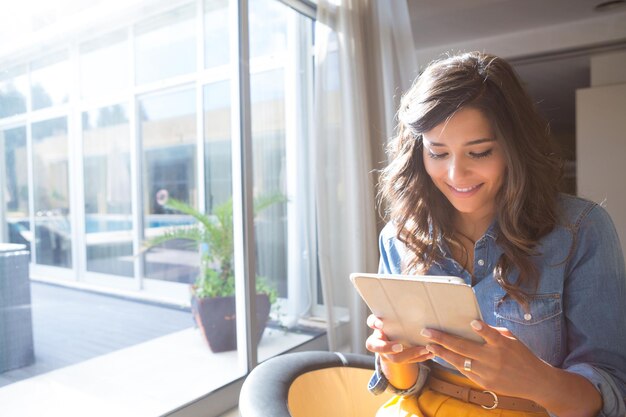 Fashion woman using tablet with sunbeams and lens flare