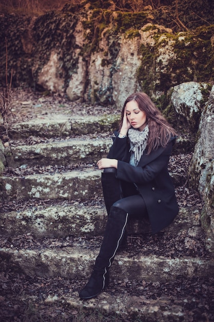 Fashion woman walking in dark autumn park