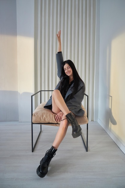 Fashion woman with long hair and legs in leather boots smile joyful emotions