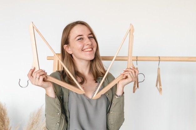 Fashion woman with wooden hangers