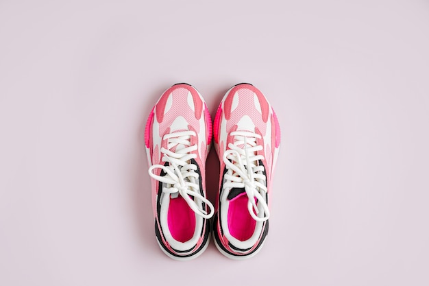 Fashion women's sneakers on a pink background. Female sport shoes.  Fitness concept.