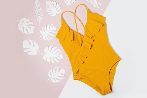 Fashion yellow swimsuit. Flat lay, top view. Summer Vacation concept.