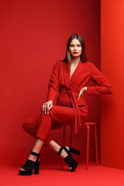 Fashion young woman in red suit