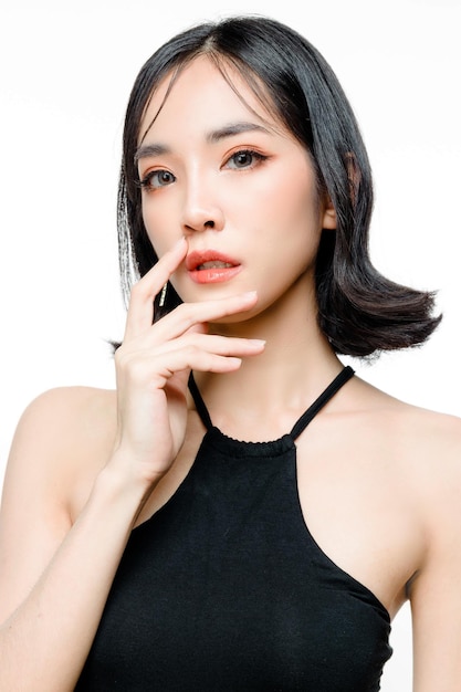 Fashionable asian woman short hair with Perfect body Cute female model with natural makeup and sparkling eyes on white isolated background Facial treatment Cosmetology beauty Concept