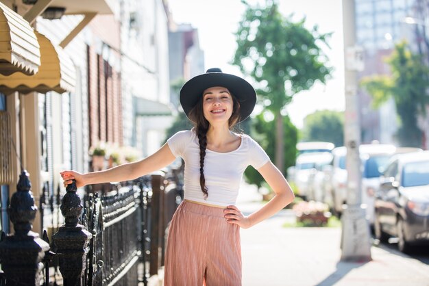 Fashionable beautiful teenager woman posing with hat