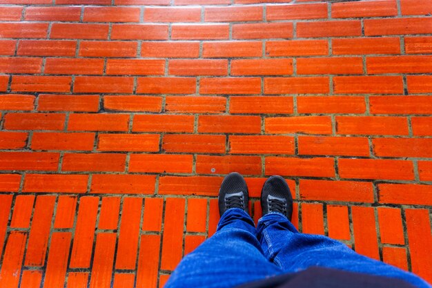 Fashionable black shoes on a red brick background