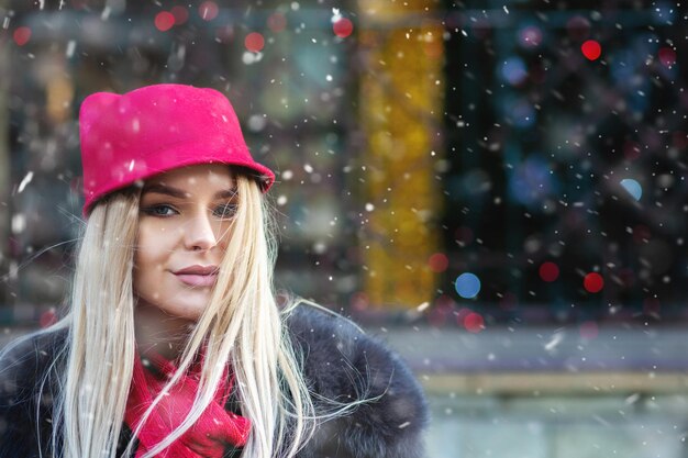 Fashionable blond woman walking at the Christmas fair. Space for text