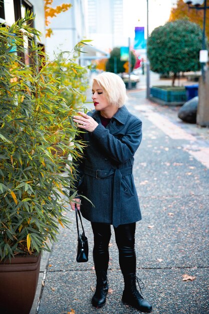 Fashionable blonde woman walking exploring the city