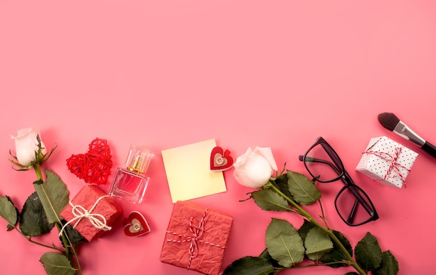 Fashionable composition with women's accessories on a pink background