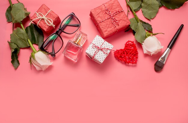 Fashionable composition with women's accessories on a pink background