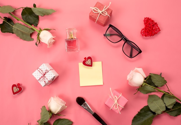 Fashionable composition with women's accessories on a pink background