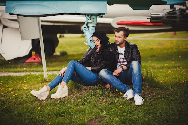 Fashionable couple sitting in leather jackets