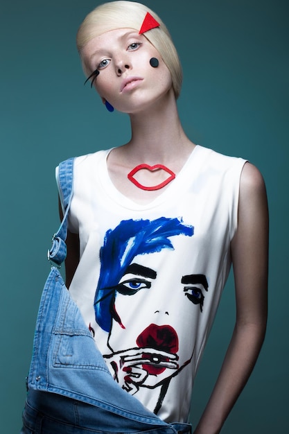 Photo fashionable girl: natural make-up, clothes with picture in style of pop art. creative image.