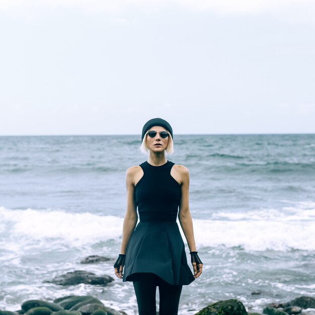 Fashionable girl on the ocean walk