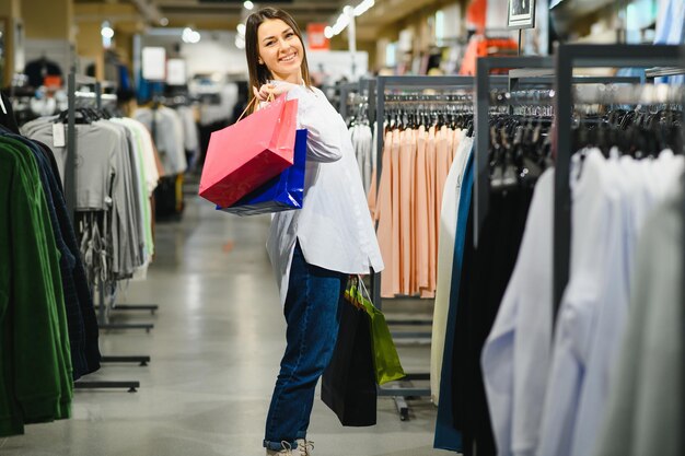 Premium Photo  Modern latina young woman choosing 100 percent organic cotton  wear in modern ecofriendly showroom young female customer shopping in  clothing store