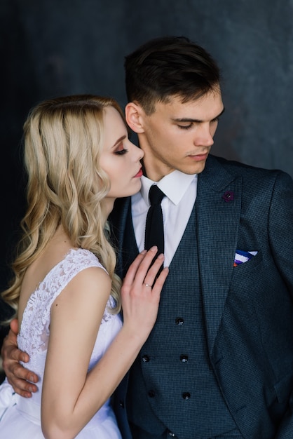 Fashionable groom and bride posing