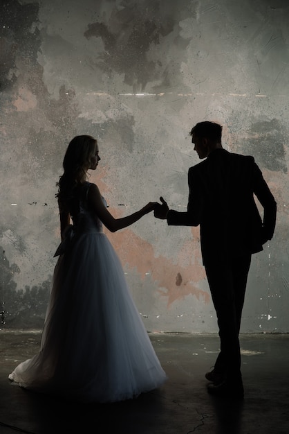 Fashionable groom and bride posing