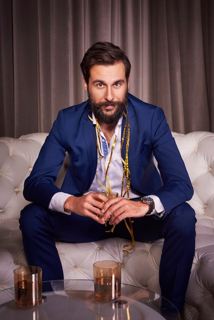 Fashionable guy posing in a blue suit