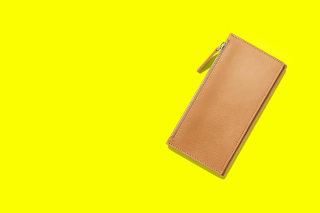 Fashionable leather women39s wallet on a yellow background added copy space for text