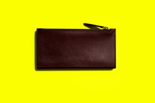 Fashionable leather women39s wallet on a yellow background added copy space for text