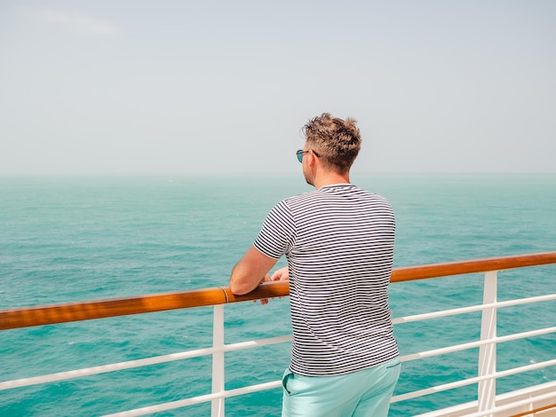 Fashionable man standing on the empty deck