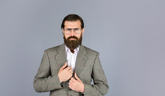 fashionable man wear glasses formal fashion model handsome man standing on gray background serious bearded businessman stylish mature man looking modern mens jacket wardrobe copy space