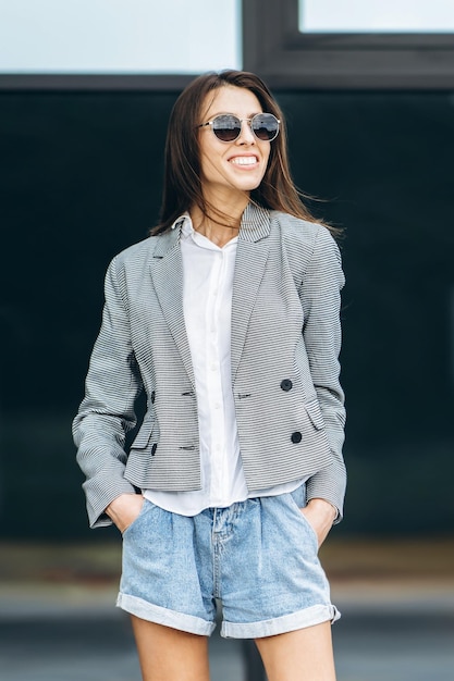 Fashionable pretty woman walking on the city street