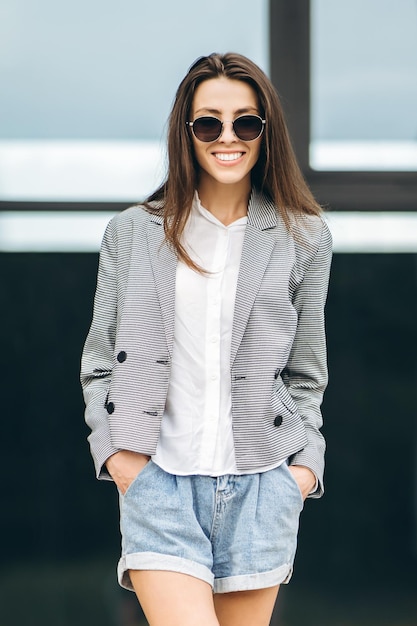 Fashionable pretty woman walking on the city street