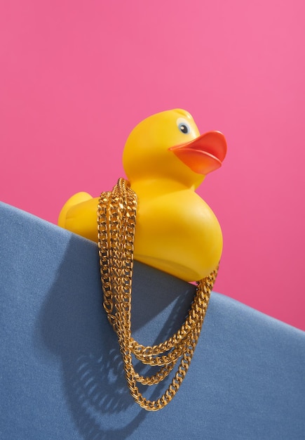 Fashionable rubber duck on the edge table with massive gold chains Luxurious composition