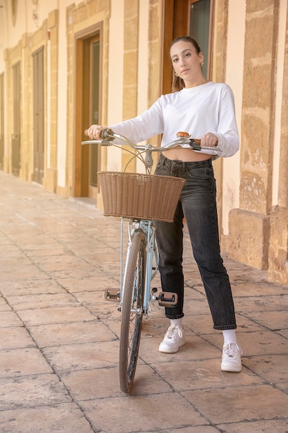 写真 シチリア島のバロック様式のアーケードで自転車とファッショナブルなシチリアの女の子