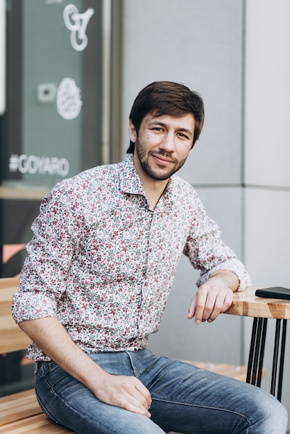 Fashionable smiling man in urban setting