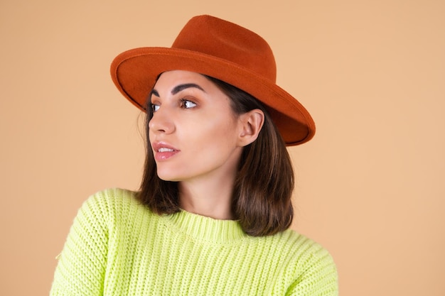 Fashionable stylish woman   in sweater and hat posing