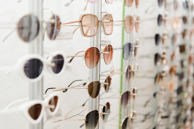 Fashionable sunglasses on the shop shelf