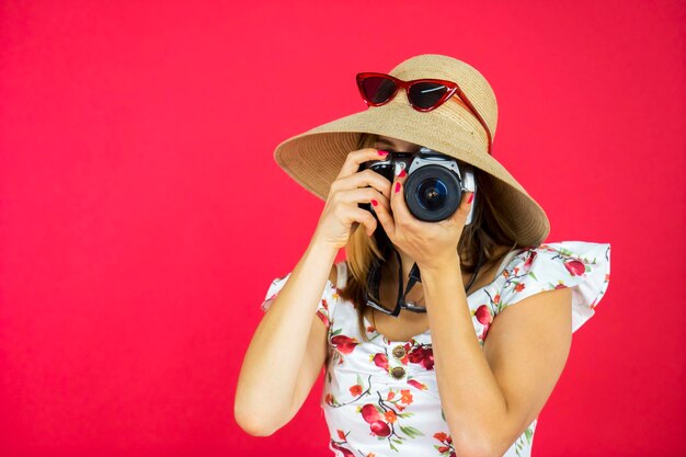 Fashionable tourist taking photo with digital camera