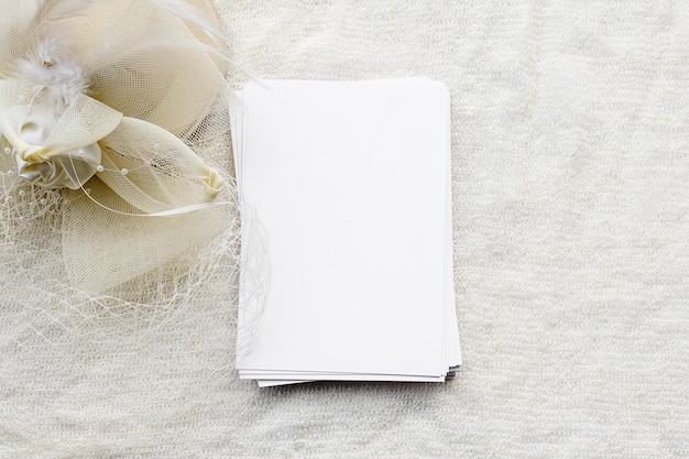 A fashionable white stock background is a blank for a postcard An empty letterhead and a white hat with a veil Female wedding background