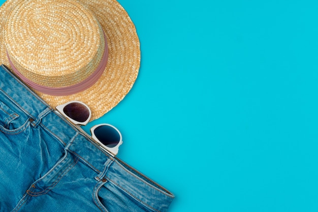 Fashionable woman clothes flatlay on blue background