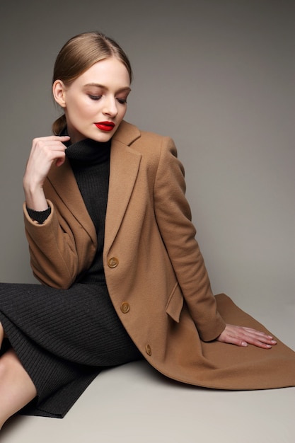 Fashionable woman in a coat. Retro style, black dress, 