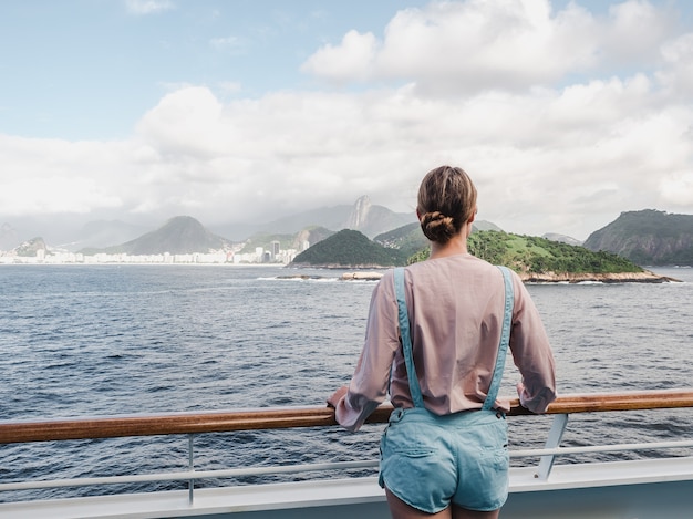 Fashionable woman on the empty deck of a cruise