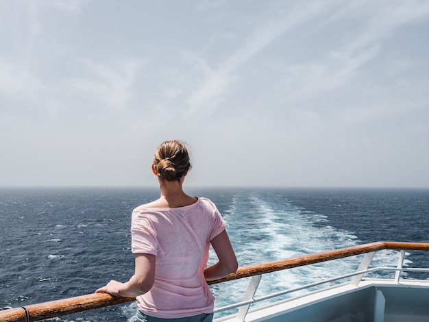 Fashionable woman on the empty deck of a cruise