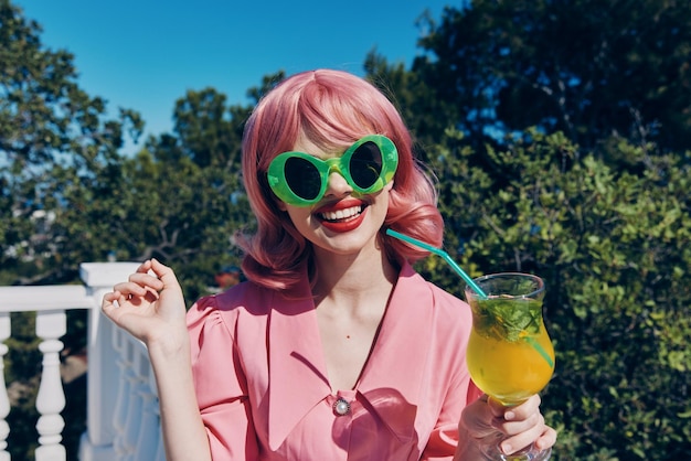 Fashionable woman green glasses glamor cocktail fun Summer day