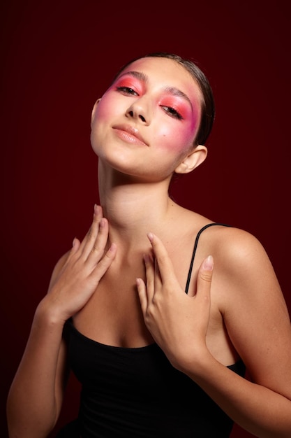 Fashionable woman pink face makeup posing attractive look skin care cropped view unaltered