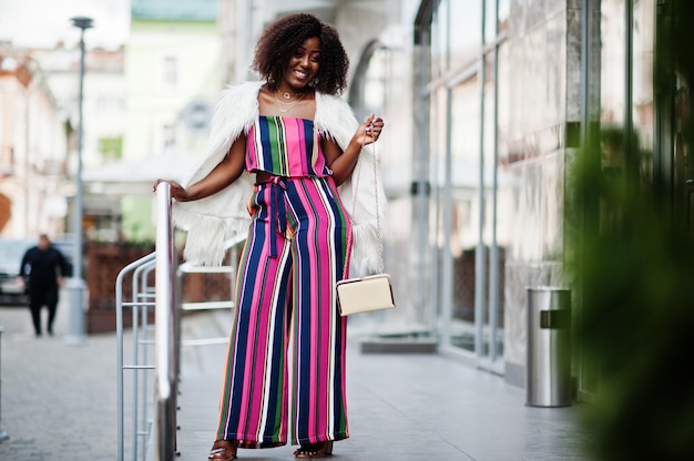 Fashionable woman in pink striped jumpsuit