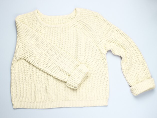 Fashionable yellow pastel knitted sweater isolated