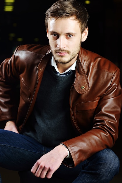 Fashionable young man with leather clothes on