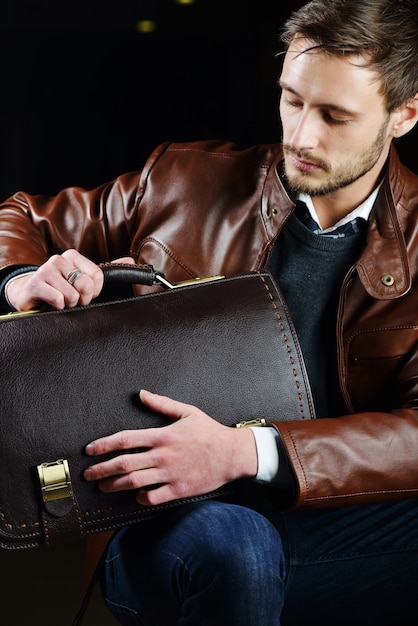 Fashionable young man with leather clothes on