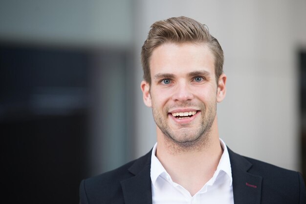 Fashionable young successful businessman. Businessman handsome attractive office worker confident face. Man well groomed elegant formal suit urban background defocused. Businessman lifestyle.