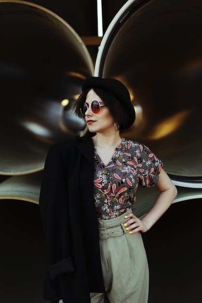 fashionable young woman wearing sunglasses while standing outdoors