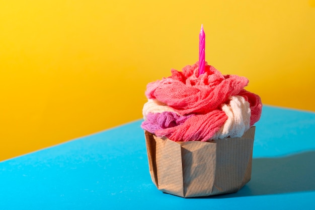 Photo fast fashion concept with materials and textiles disguised as cupcake